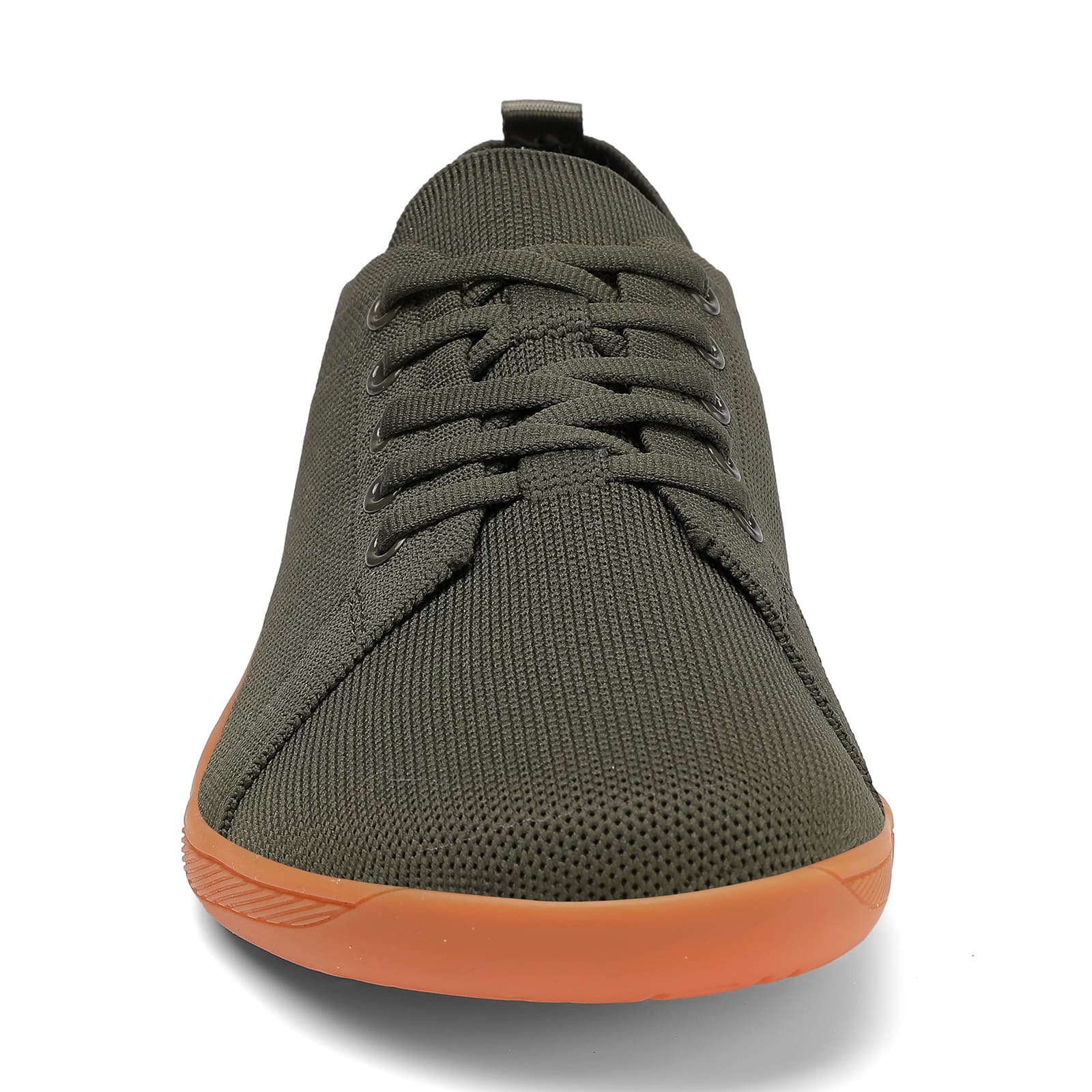 Green sneaker with orange sole on a white background
