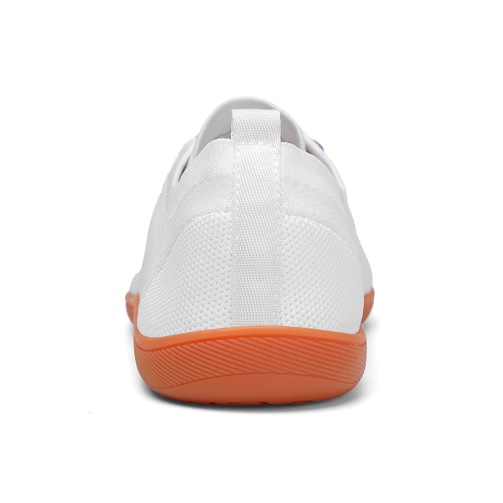White sneaker with orange sole on a white background