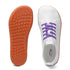 White sneaker with purple laces and orange sole on a white background