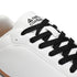 Detail of black laces and tongue branding on Walker Leather barefoot shoes in white