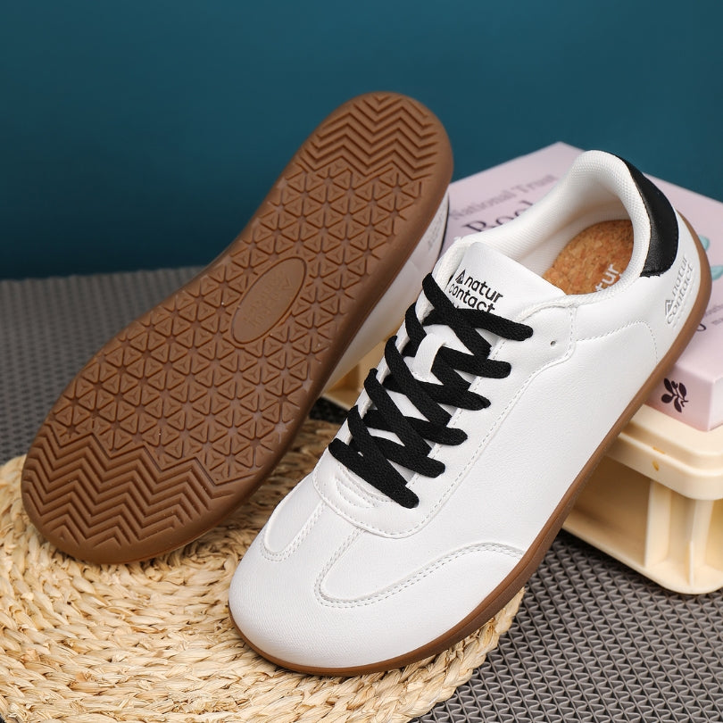 Walker Leather barefoot shoes in white and black displayed as a styled product shot for everyday use