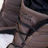 Close-up of brown Naturcontact winter boots with black laces and black faux fur lining, showing detailed stitching and padded design
