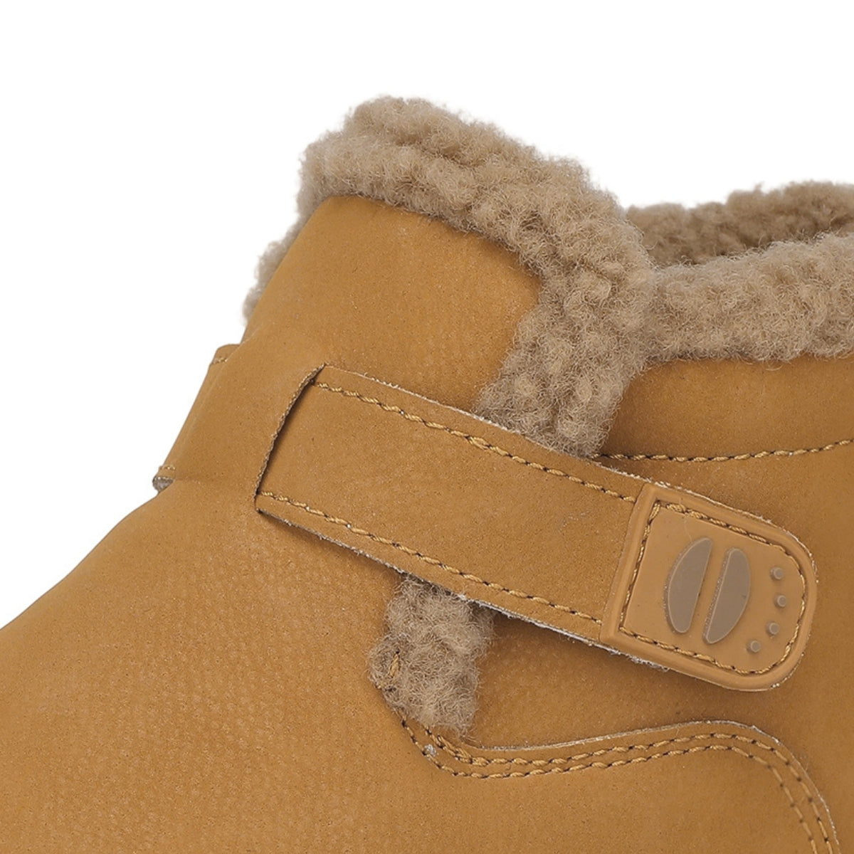 Close-up of a tan suede boot with a fuzzy beige shearling lining and a hook-and-loop strap closure on a white background.