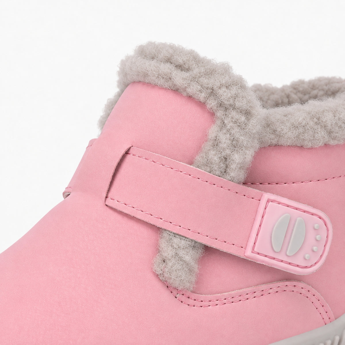 A close-up of a pink children's winter boot featuring a soft gray faux-fur collar and a matching pink hook-and-loop strap closure with a gray buckle.